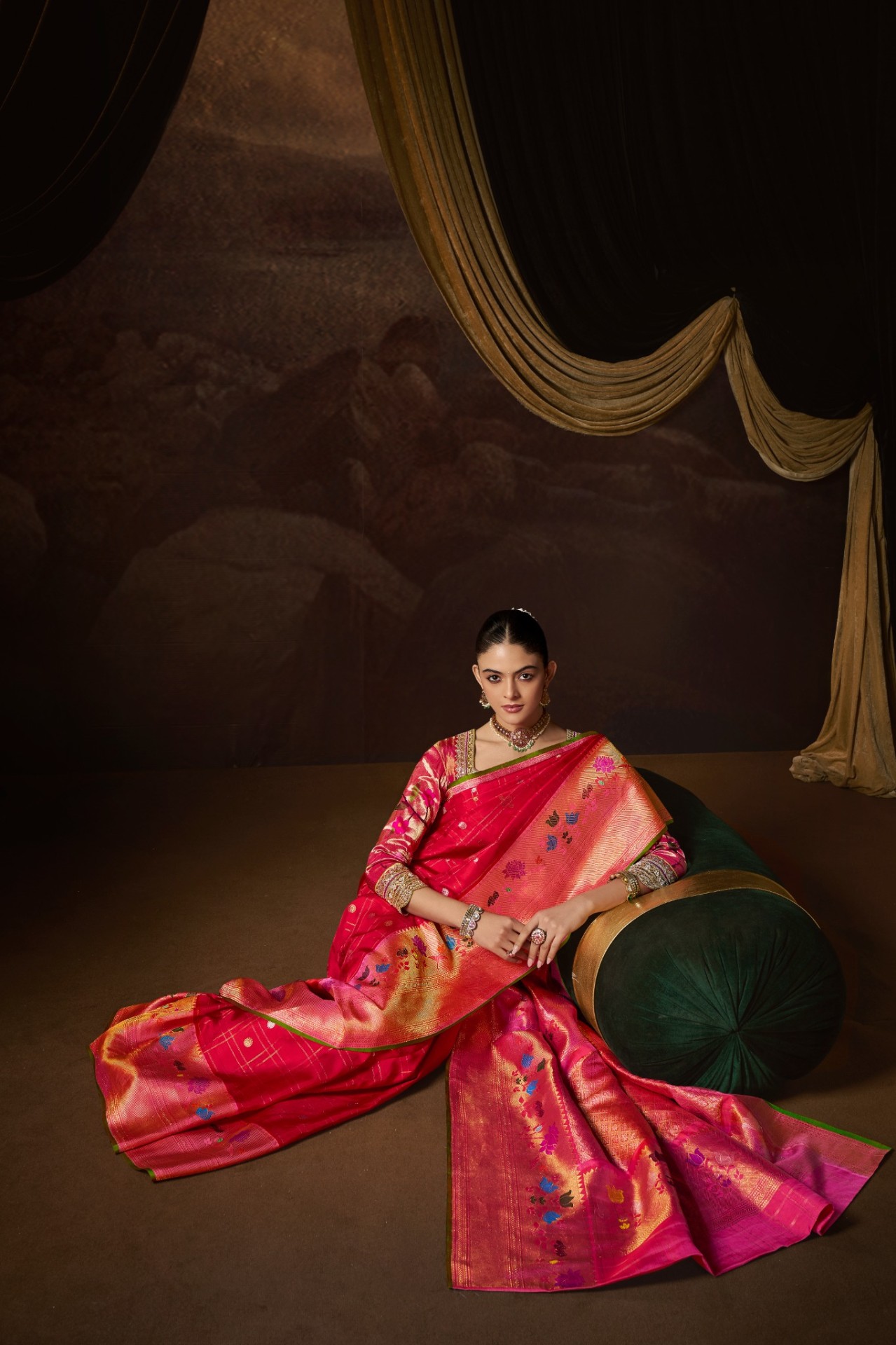 A bride in a rose-pink Paithani saree with gold zari border, photographed at the Trisha Silks atelier